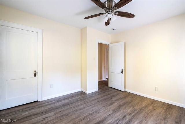 unfurnished bedroom featuring ceiling fan and dark hardwood / wood-style flooring