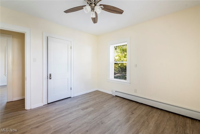 unfurnished bedroom featuring light hardwood / wood-style floors, baseboard heating, and ceiling fan