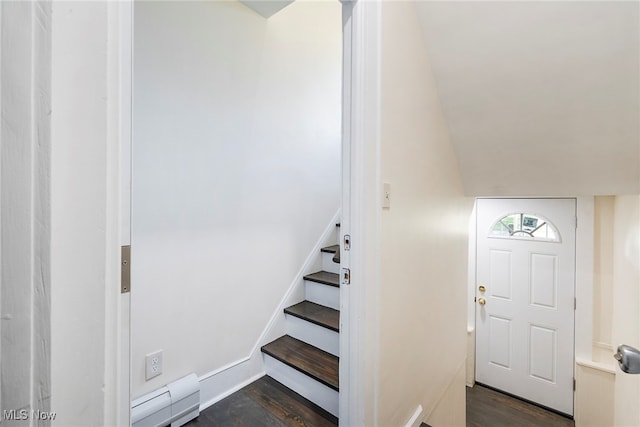 staircase with hardwood / wood-style floors and vaulted ceiling