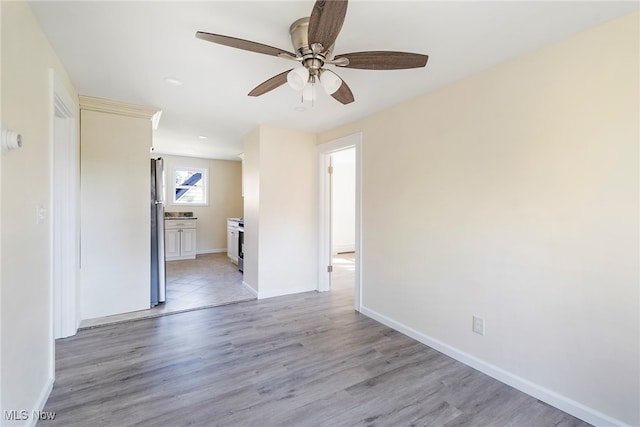 unfurnished room with light hardwood / wood-style flooring and ceiling fan