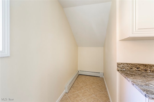 interior space featuring a baseboard radiator and light tile patterned floors