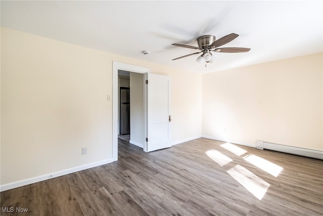 unfurnished room with light hardwood / wood-style floors, baseboard heating, and ceiling fan