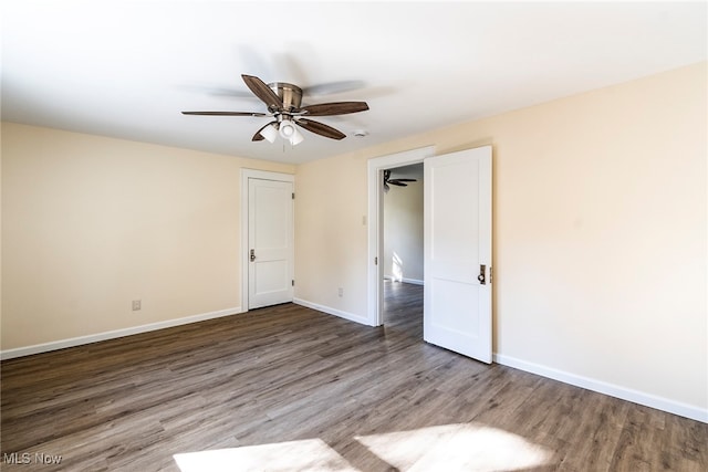 empty room featuring hardwood / wood-style flooring and ceiling fan