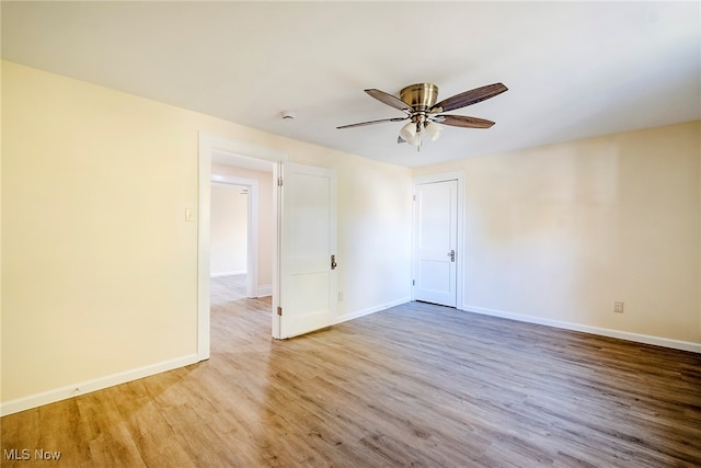 empty room with light wood-type flooring and ceiling fan