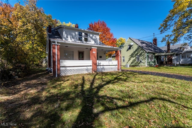 view of front of home with a porch and a front lawn