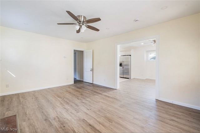 unfurnished room featuring ceiling fan and light hardwood / wood-style flooring