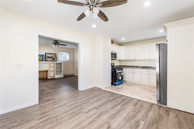 kitchen featuring light hardwood / wood-style floors, white cabinets, stainless steel appliances, and ceiling fan