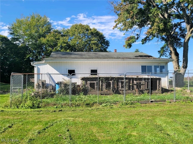 rear view of property with a yard