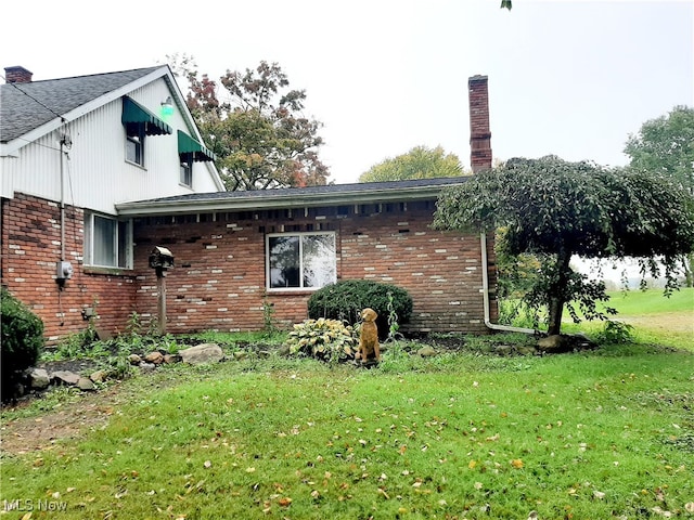 view of property exterior with a lawn