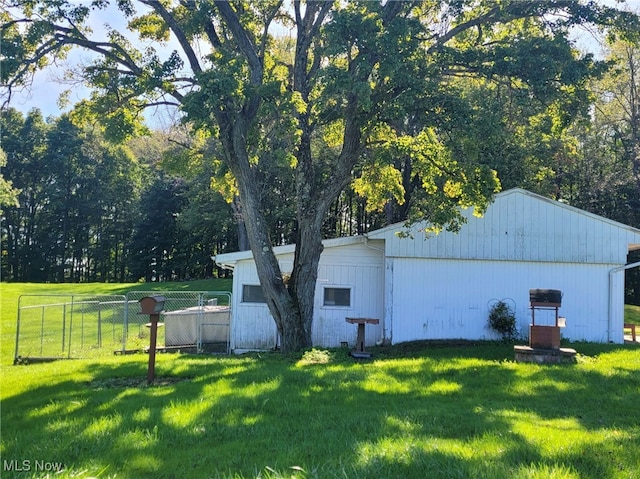 view of side of property with a lawn