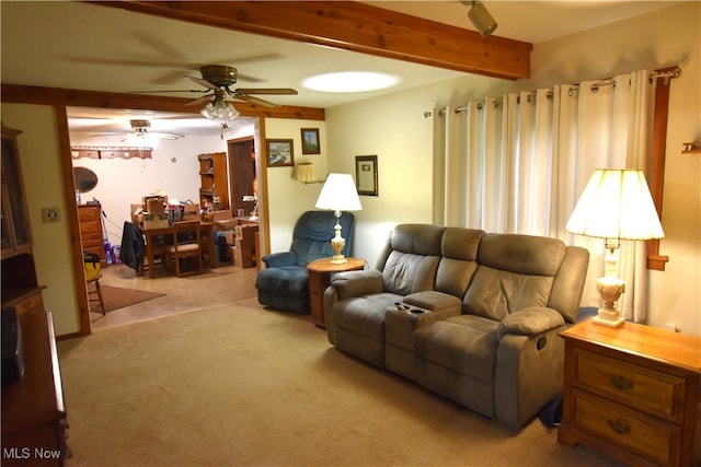 carpeted living room featuring ceiling fan and beam ceiling