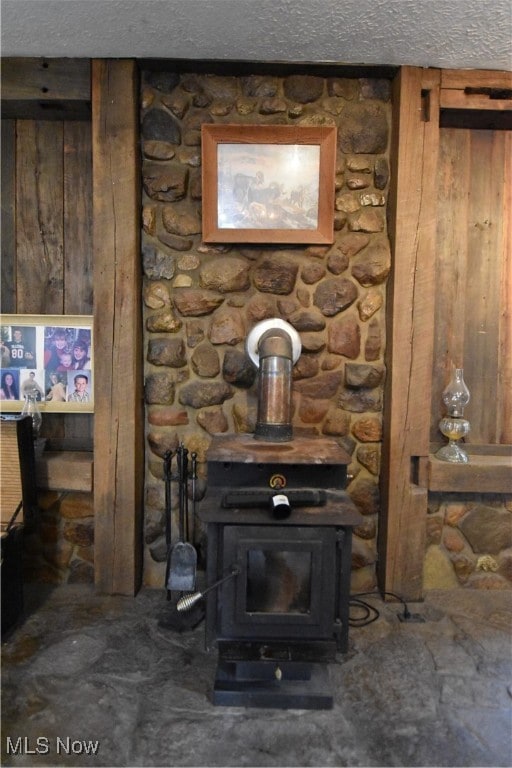 interior details with a wood stove and wood walls