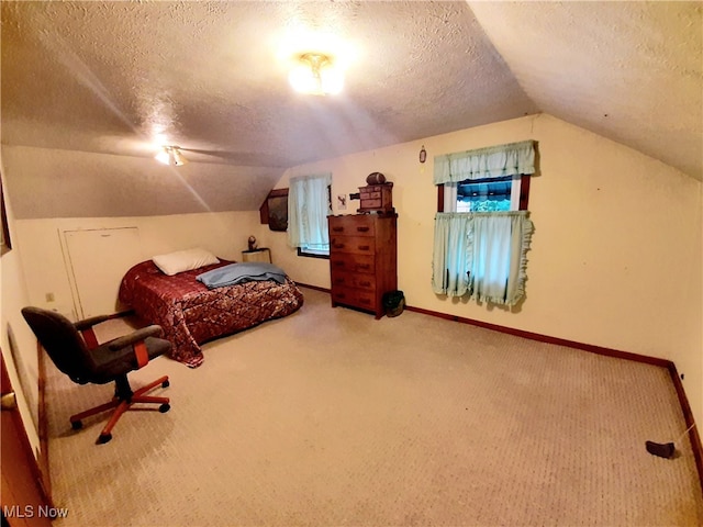 bedroom with carpet, a textured ceiling, and vaulted ceiling