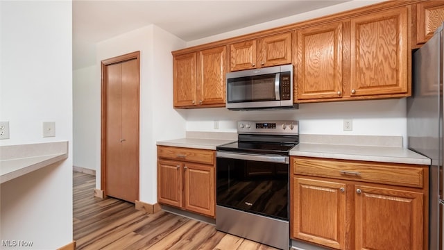 kitchen with light hardwood / wood-style flooring and stainless steel appliances