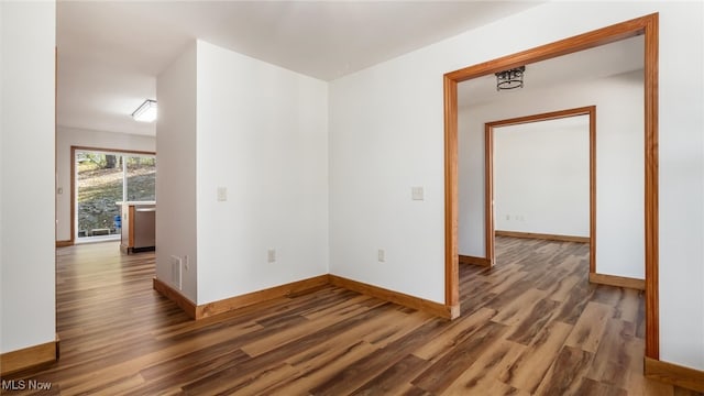 spare room with dark hardwood / wood-style flooring