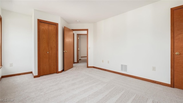 unfurnished bedroom featuring light carpet