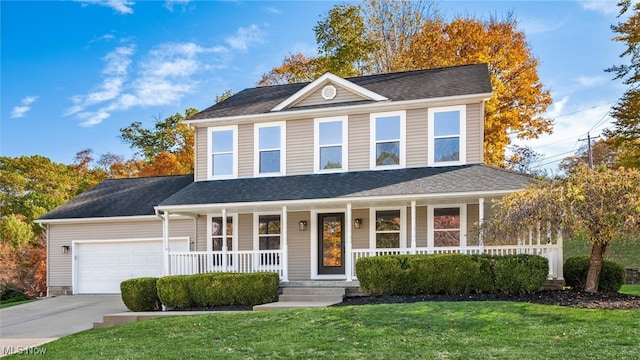 view of front of house with a porch, a front yard, and a garage