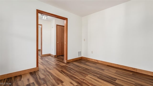 spare room with hardwood / wood-style floors