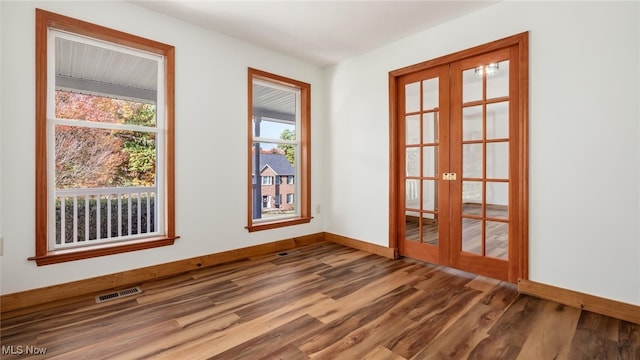 spare room featuring french doors and hardwood / wood-style floors