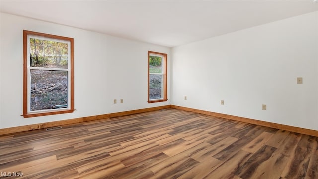 empty room with hardwood / wood-style flooring