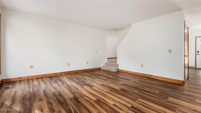 spare room featuring wood-type flooring