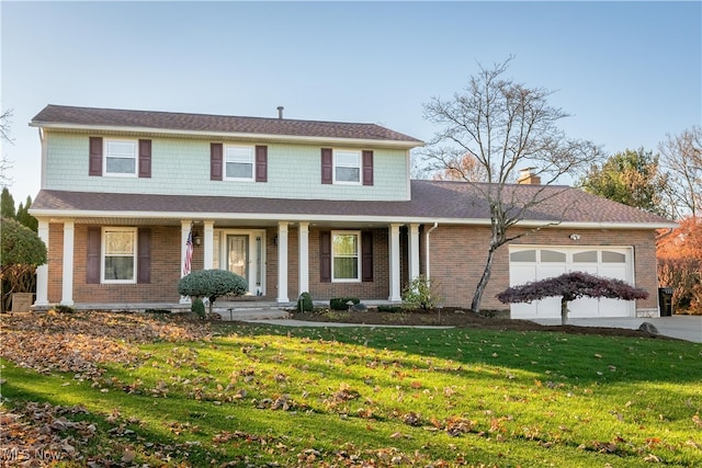 view of front of home featuring a garage and a front lawn