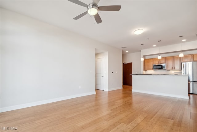 unfurnished living room featuring light hardwood / wood-style floors and ceiling fan