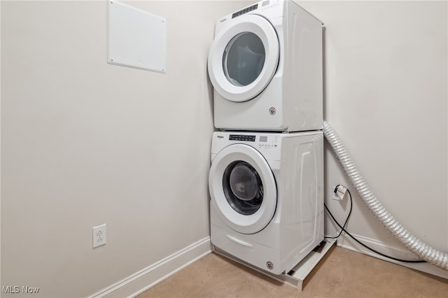 laundry area with light colored carpet and stacked washer and dryer