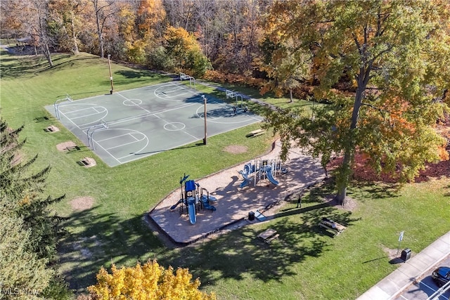 view of sport court featuring a playground and a yard