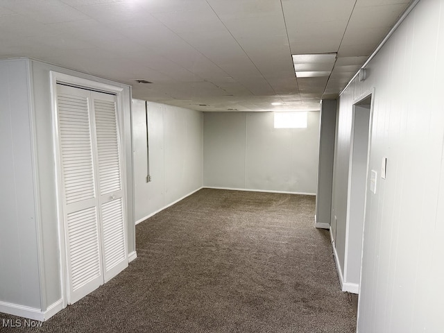 basement featuring dark carpet