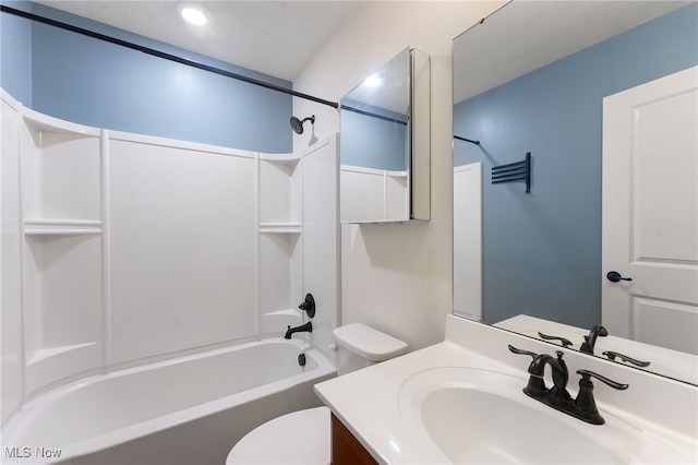 full bathroom with toilet, a textured ceiling, vanity, and washtub / shower combination