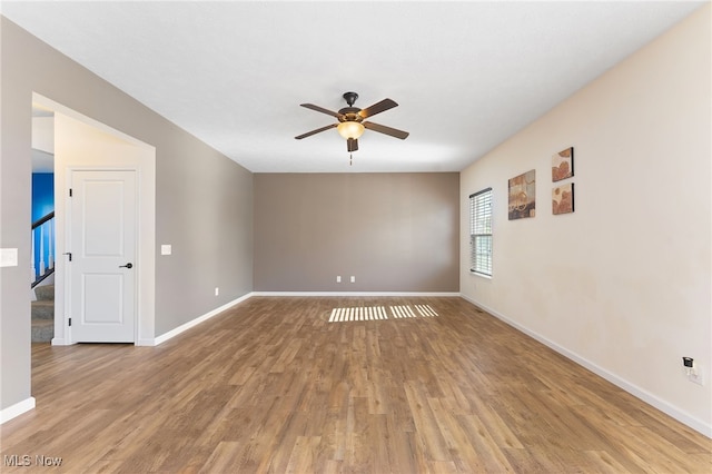 empty room with light wood-type flooring and ceiling fan