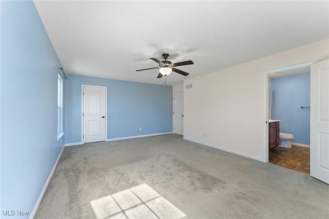 unfurnished bedroom with carpet floors, ensuite bath, and ceiling fan