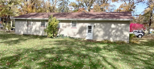 view of side of home with a yard