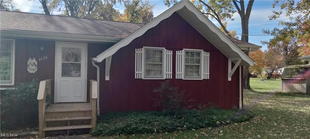 view of outbuilding with a lawn