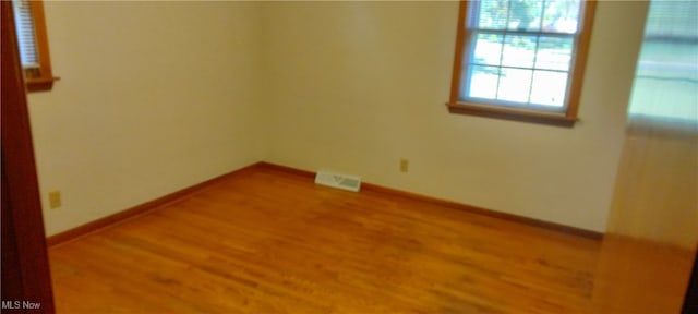 spare room featuring hardwood / wood-style floors