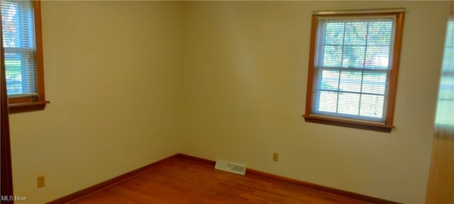 unfurnished room featuring hardwood / wood-style floors