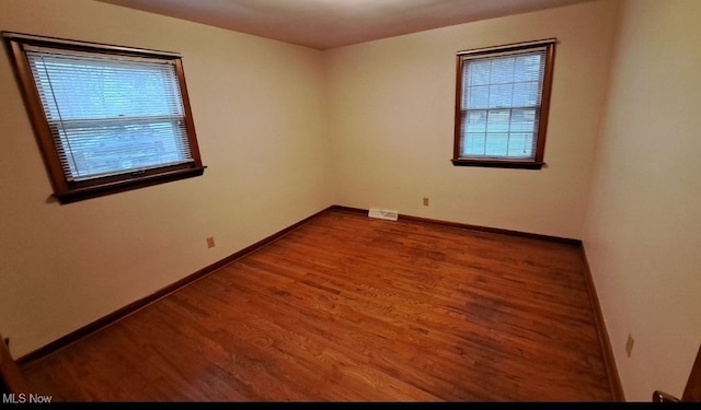 spare room with wood-type flooring