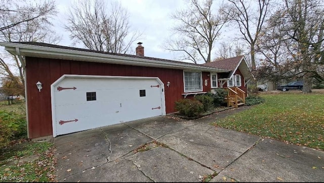 view of home's exterior featuring a garage and a yard