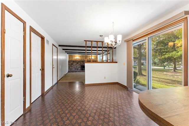 unfurnished dining area with a notable chandelier and a fireplace