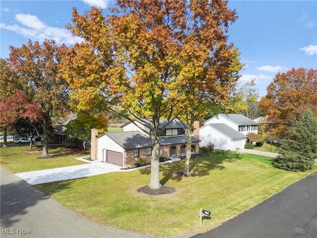 view of front of home with a front yard and a garage