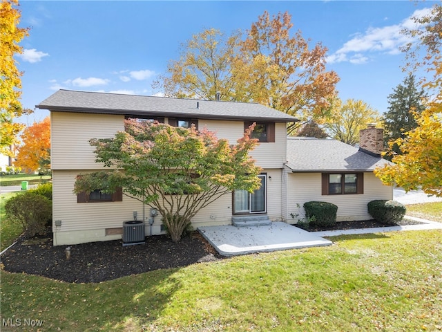 back of house featuring a patio, a lawn, and central AC unit