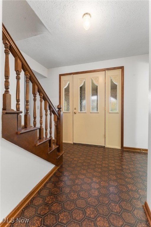 foyer with a textured ceiling