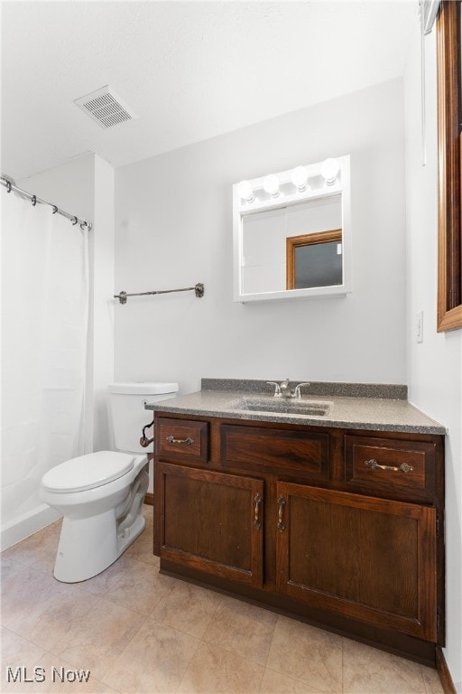 bathroom with vanity, toilet, and walk in shower