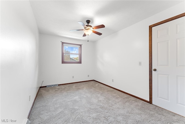 carpeted spare room with ceiling fan