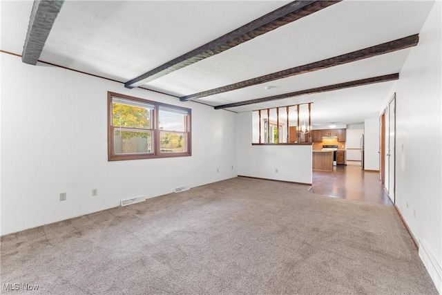 unfurnished living room featuring beam ceiling and carpet floors