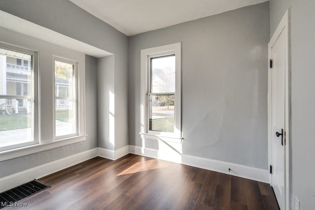 spare room with dark hardwood / wood-style floors