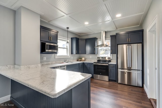 kitchen featuring kitchen peninsula, dark hardwood / wood-style floors, stainless steel appliances, and hanging light fixtures