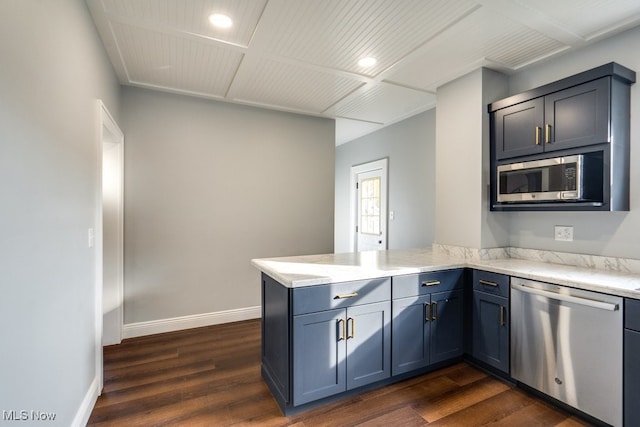 kitchen featuring kitchen peninsula, light stone counters, stainless steel appliances, dark wood-type flooring, and blue cabinets