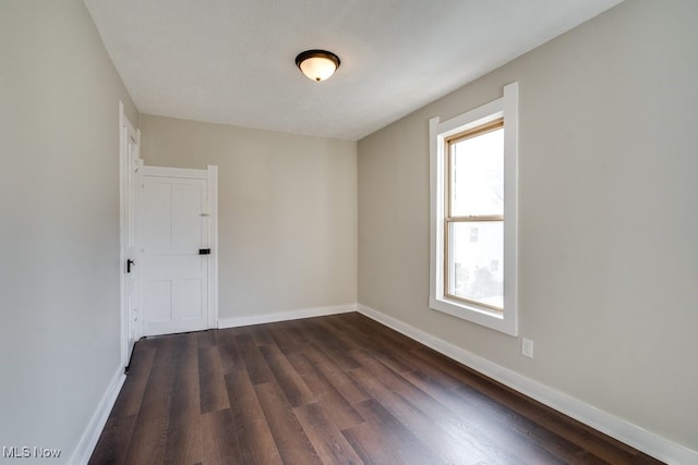 spare room featuring dark hardwood / wood-style floors